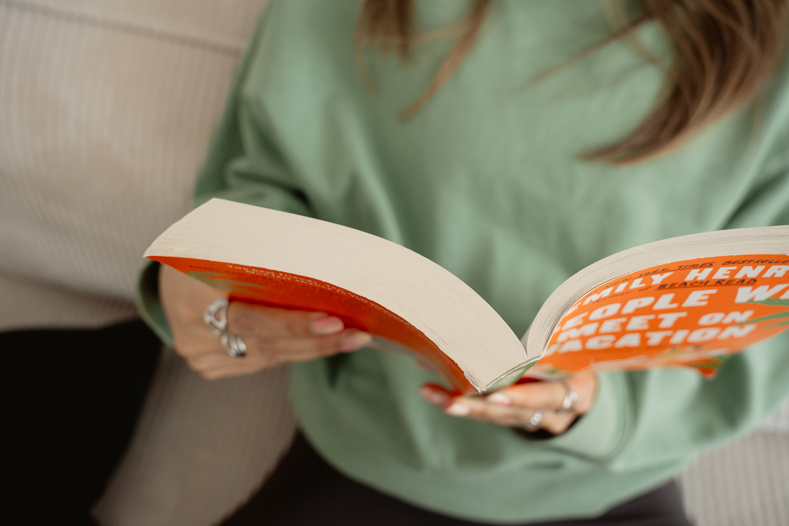 A woman reading in bed at night, wearing tacet